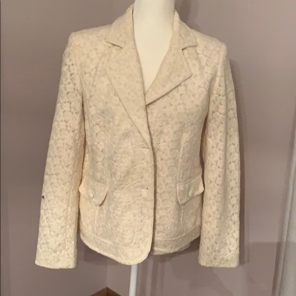 Ivory blazer with embroidery detail.